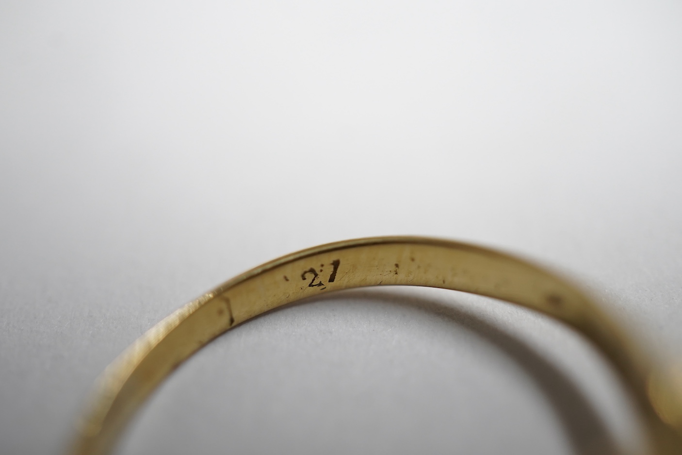 An early 20th century yellow metal and three stone ruby set ring, the centre stone bordered with rose cut diamonds, size H/I, gross weight 2.8 grams.